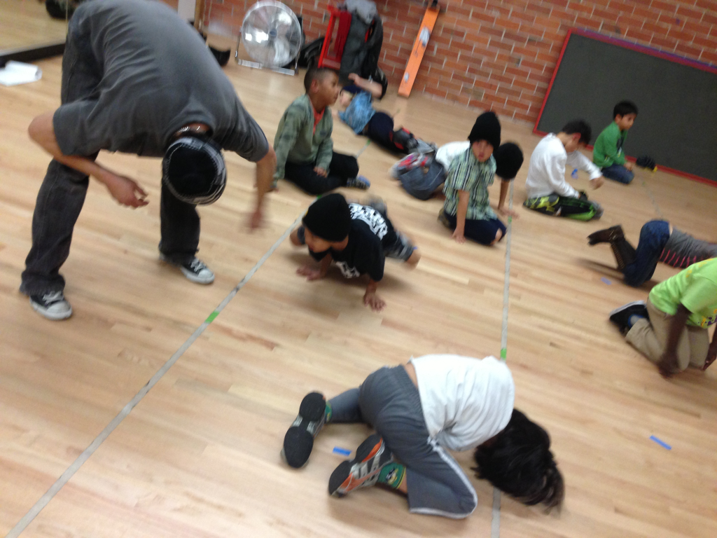 Drew Looner coaches students practicing low balances and floor positions at Destiny Arts in Oakland.