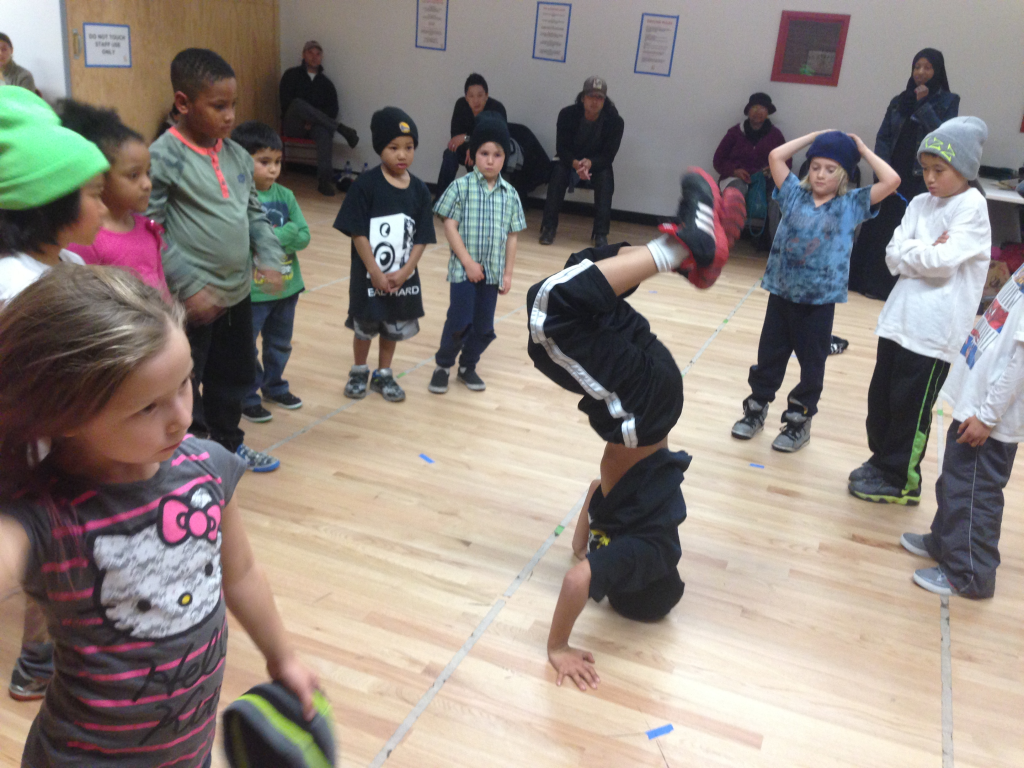 A student practices a headstand as classmates watch during a breaking class at Destiny Arts in Oakland.
